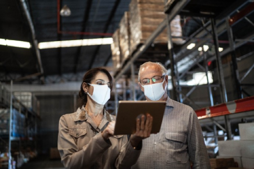 ey-man-and-woman-using-digital-tablet-in-warehouse-wearing-masks-meta.png